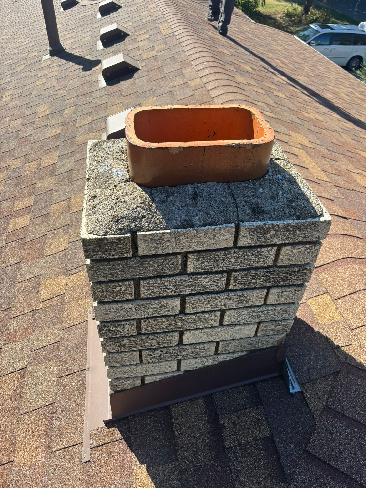 B Chimney Services technician replacing a rusted metal chase cover with a stainless steel upgrade on an Eagan, MN home.