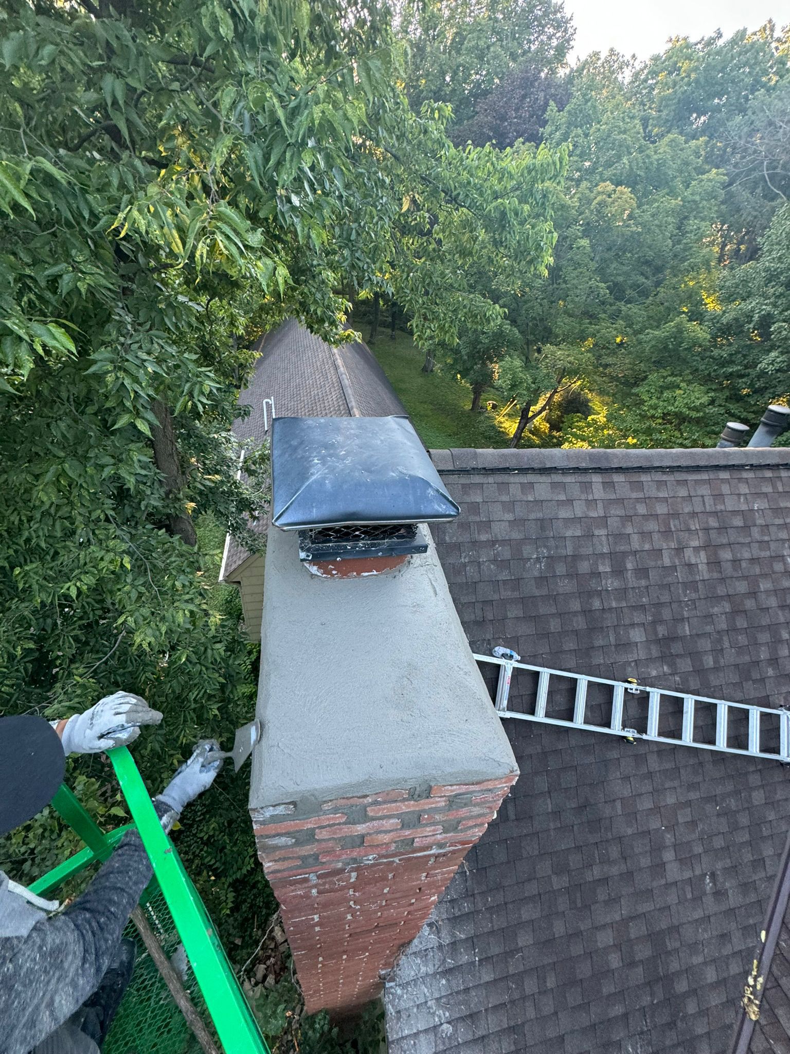 JB Chimney Services masonry crew repairing a large stone chimney on an acreage estate in Lake Elmo, MN.
